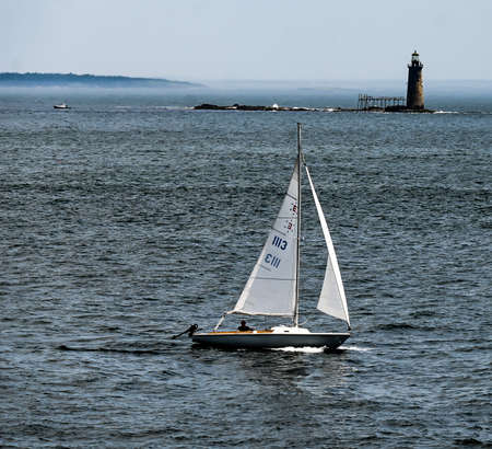 Sailboat with a lighthouse in the backgroundのeditorial素材