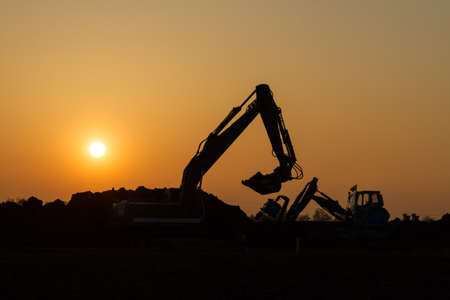Construction vehicles in the sunset