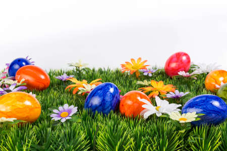 Flower meadow with colorful Easter eggs in landscape modeの写真素材