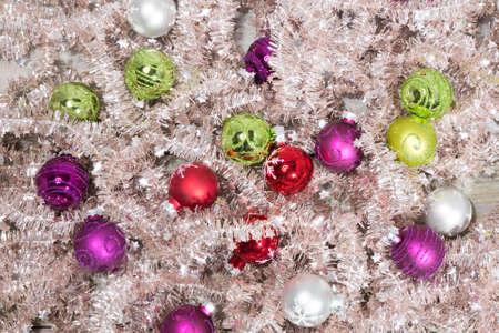 little colored christmas balls on tree garlandの写真素材