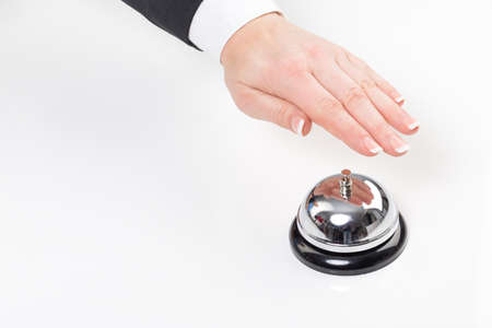female hand ring a bell at a hotel or receptionの写真素材