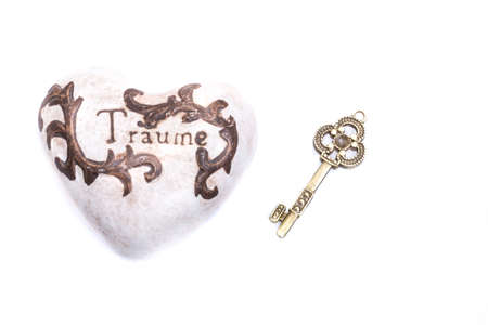 white stone heart with ornaments and key to dreamsの写真素材