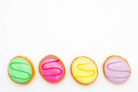 four pastry pieces with colorful sweet icingの写真素材