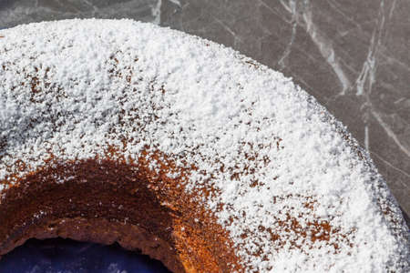 chocolate, nut, sponge cake sprinkled with icing sugarの写真素材