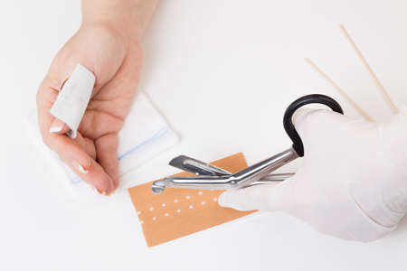 getting a bandage at a thumbs with a deep cutの写真素材