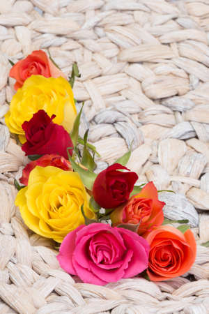 blossoms of roses builing a frame before a basket struktureの写真素材