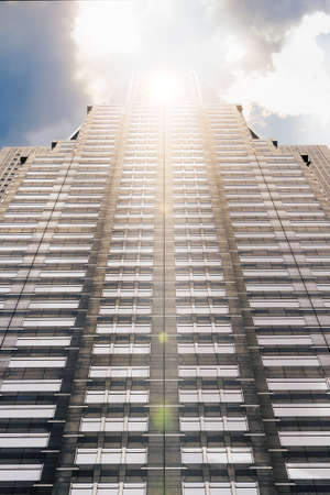 skyscraper in tokyo japan with a sunbeam against his facadeの写真素材