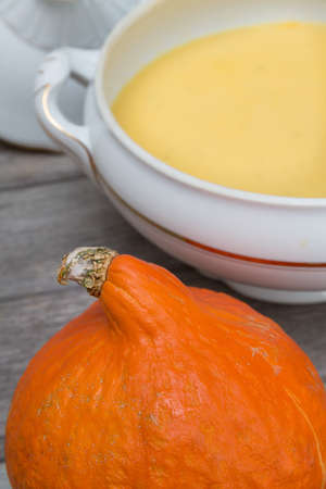 set with a pumpkin, with pumpkin soup, spon, a spoup bowl and breadの写真素材