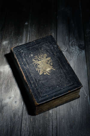 bible in the night, lying on a wooden table
