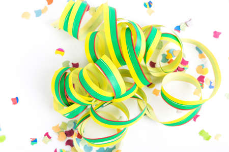 green and yellow streamer with confetti against white background