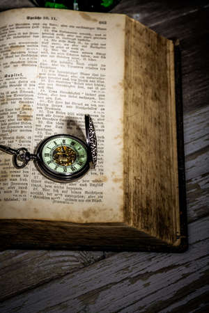 bible with a steampunkt clock as still life for halloweenの写真素材