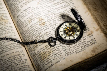 bible with a steampunkt clock as still life for halloweenの写真素材