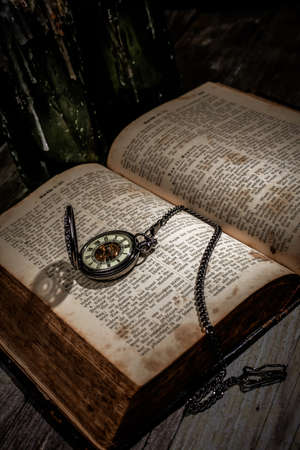 bible with a steampunkt clock as still life for halloweenの写真素材