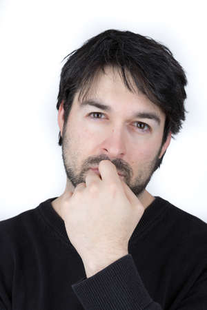 portrait of a man with beard who brooding