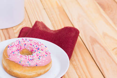 sweet delicious pink donut with colorful sprinklesの写真素材