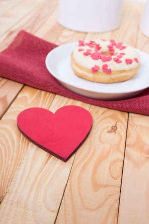 sweet tasty donut with white glaze red sugar  hearts and red heart for decorationの写真素材