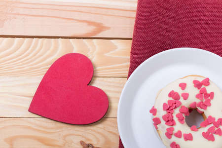 sweet tasty donut with white glaze red sugar  hearts and red heart for decorationの写真素材