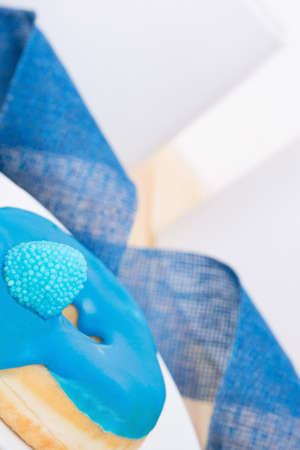 sweet delicious blue donut with colorful glaze and a sugar berryの写真素材