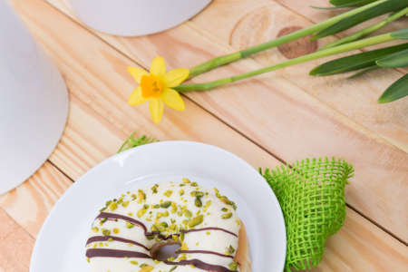 sweet delicious donut with white icing and pistachiosの写真素材