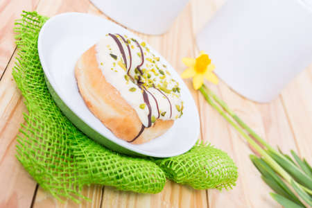 sweet delicious donut with white icing and pistachiosの写真素材