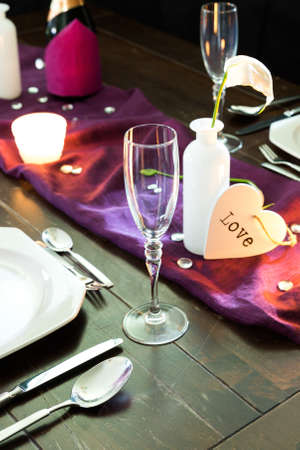 table with place setting for two persons in violet colorsの写真素材