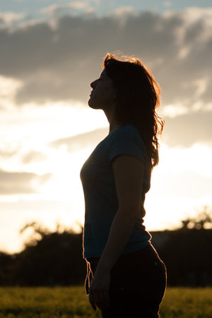 silhouette of a woman against the sun