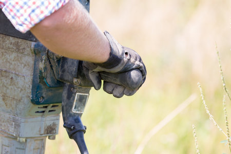 Worker with a gas welding torch in the field, close-up