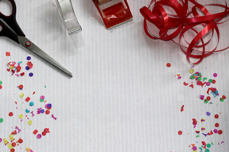 top view of a scissors and duct tapes and confetti photographed with macro lens with copy spaceの写真素材