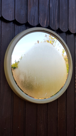 a frozen mirror on a wooden wall in the winter wonderland of the district of emsland Germany...