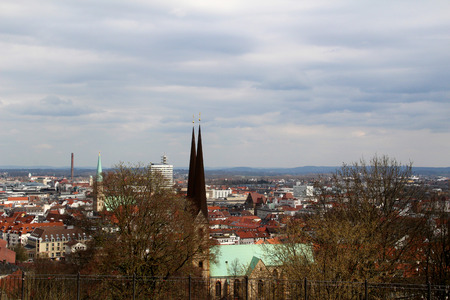view from the rooftop of the sparrenburg in bielefeld germany photographed in multi colored during a sightseeing tour on a cloudy dayのeditorial素材