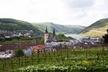 Distant view on buildings in the middle of the hills in bingen at the rhine in hesse germany photographed on a sightseeing tour at a cloudy dayの写真素材