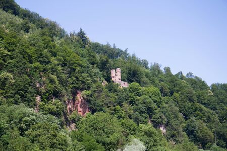 View on a tower in the forest photographed during a tour by ship on the neckar in germanyの写真素材