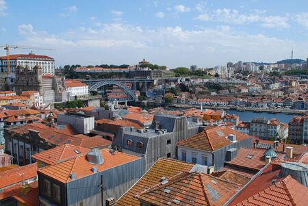 Colored facades and roofs of houses in Porto, Portugal. Left side: Ponte Luis I. Porto is the second-largest city in Portugal after Lisbonのeditorial素材