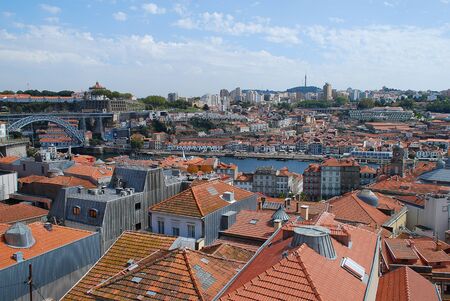 Colored facades and roofs of houses in Porto, Portugal. Left side: Ponte Luis I. Porto is the second-largest city in Portugal after Lisbonの写真素材