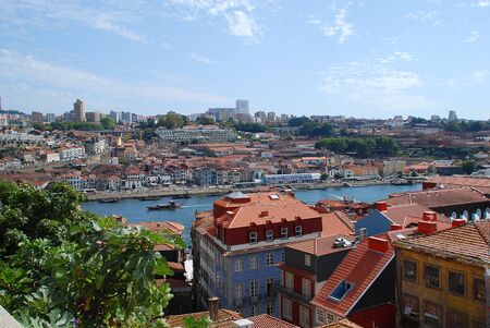 Colored facades and roofs of houses in Porto and the river Douro, Portugal. Porto is the second-largest city in Portugal after Lisbonの写真素材