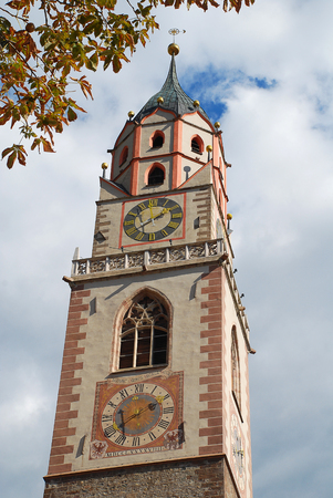 Meran, South Tyrol, Italy: The tower of St. Nicholas' Church. The church is dedicated to Saint Nicholas, the patron saint of the townの写真素材