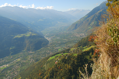 Panorama view on valleys and mountains (Texel Group) in the italian alps standing at the cableway station Hochmuth (Meran, South Tyrol, Italy)の写真素材