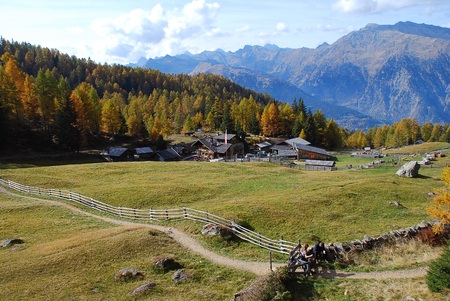Hiking in the 'Hirzer' area with impressive autumn scenery, Sarntal Alps, South Tyrol, Italy. In the foreground the mountain innの写真素材