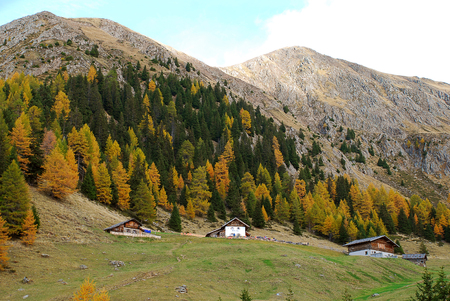 Hiking in the 'Hirzer' area with impressive autumn scenery, Sarntal Alps, South Tyrol, Italy. In the foreground the mountain innの写真素材