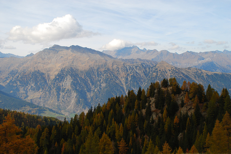Hiking in the 'Hirzer' area with impressive autumn scenery, Sarntal Alps, South Tyrol, Italy. In the distance the mountains of the Texel group and the Passeier Valleyの写真素材
