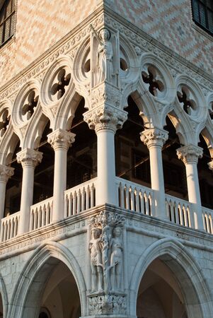 Venice, Italy: Detail of the Doge Palace with statues of Adam and Eve, above it Lady Justice with sword and scrollの写真素材