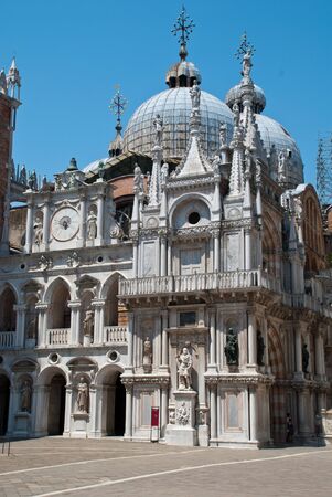 Venice, Italy: The Arco Foscari is in the courtyard of the Doge's Palace (Ital.: Palazzo Ducale), San Marco basilica behind itの写真素材