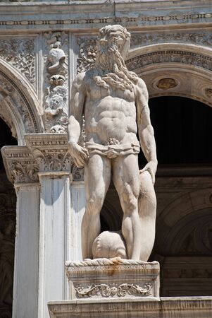 Venice, Italy: A statue of Neptune - The Roman God of the Sea, located at the Giants Staircase at the Doges Palace (Palazzo Ducale). The statue represents Venice's power by seaの写真素材