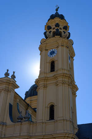Munich, Germany: Clock tower at baroque Theatine church at Odeonsplatz in the city of Munichの写真素材