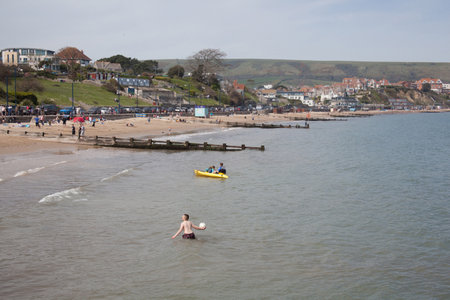 People enjoying the beach in Swanage, Dorset in the UKのeditorial素材