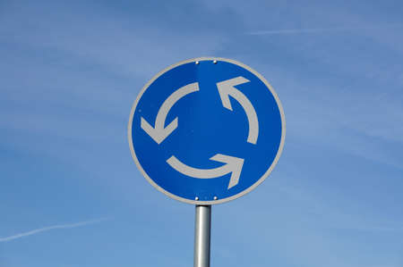 roundabout traffic sign in blue sky                   の写真素材