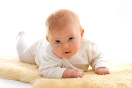 lying baby looks at the camera