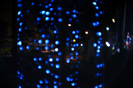 Blue spot light is out of focus on the road when time about 7-8 pm.の写真素材