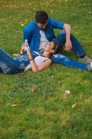 Love couple at the park. Looking each other and smiling.の写真素材