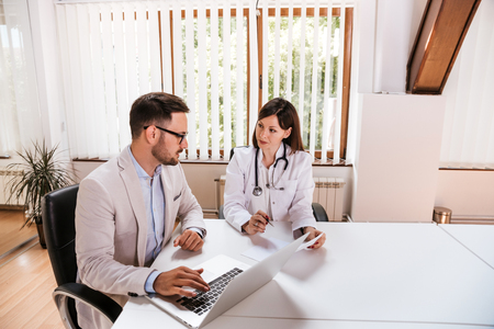 Female doctor discussing with manager.の写真素材